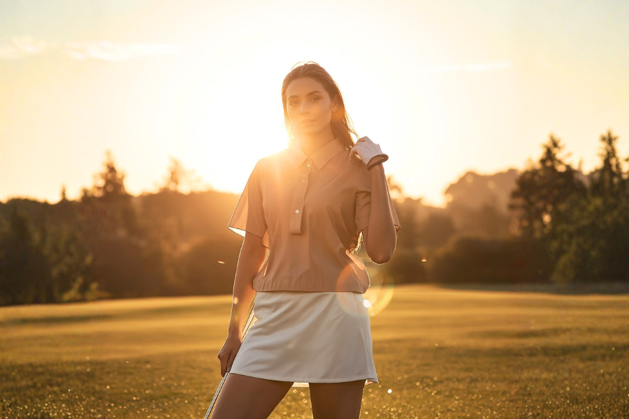 woman golfer during golden hour feeling good